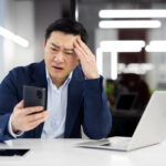 Business owner reviewing delivery information while deciding between courier service options